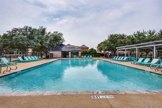 view of pool with a patio and a pergola