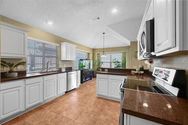 kitchen with sink, white cabinets, a textured ceiling, and appliances with stainless steel finishes