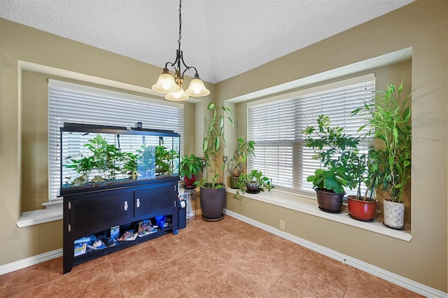 miscellaneous room featuring tile patterned floors, an inviting chandelier, and a textured ceiling