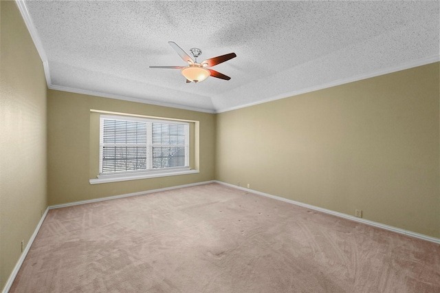 carpeted spare room featuring a textured ceiling, ceiling fan, and crown molding