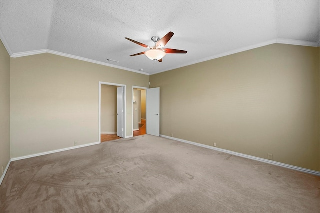 carpeted empty room with a textured ceiling, ceiling fan, crown molding, and lofted ceiling