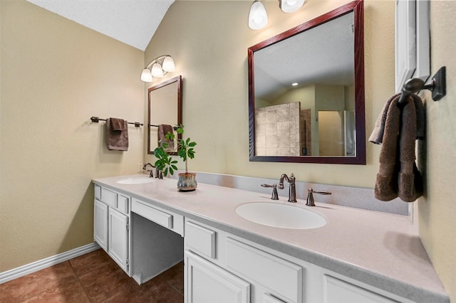 bathroom featuring walk in shower, tile patterned floors, vanity, a textured ceiling, and lofted ceiling