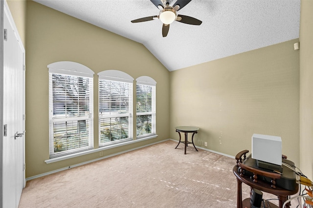 sitting room with lofted ceiling, a textured ceiling, ceiling fan, and light colored carpet