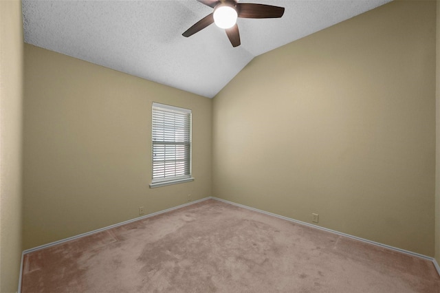 carpeted empty room with a textured ceiling, ceiling fan, and vaulted ceiling