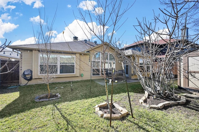 back of property featuring a yard and a patio area