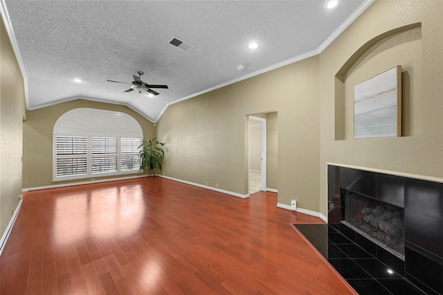 unfurnished living room with ornamental molding, a fireplace, hardwood / wood-style flooring, a textured ceiling, and lofted ceiling