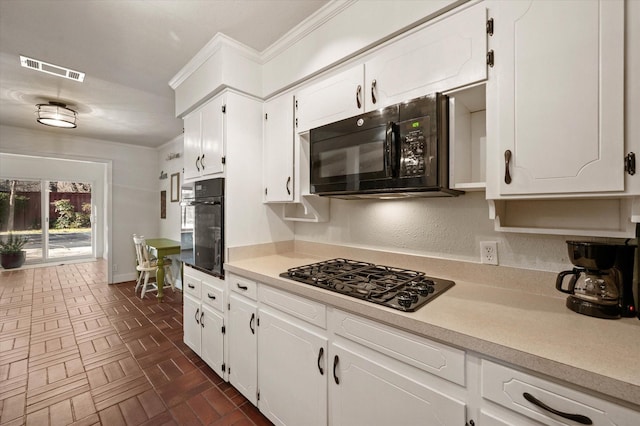 kitchen featuring white cabinetry, black appliances, and ornamental molding