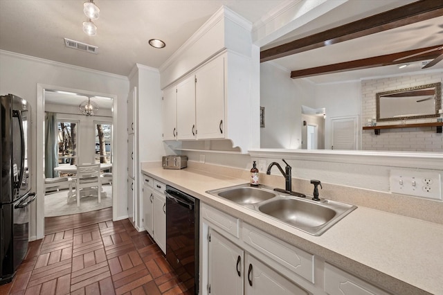 kitchen featuring sink, white cabinets, dark parquet flooring, and black appliances