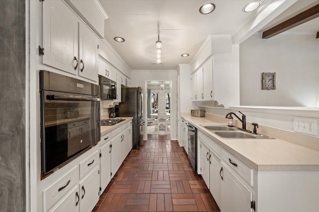 kitchen featuring black appliances, sink, and white cabinetry