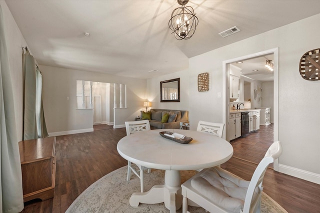 dining area featuring a notable chandelier and dark hardwood / wood-style flooring