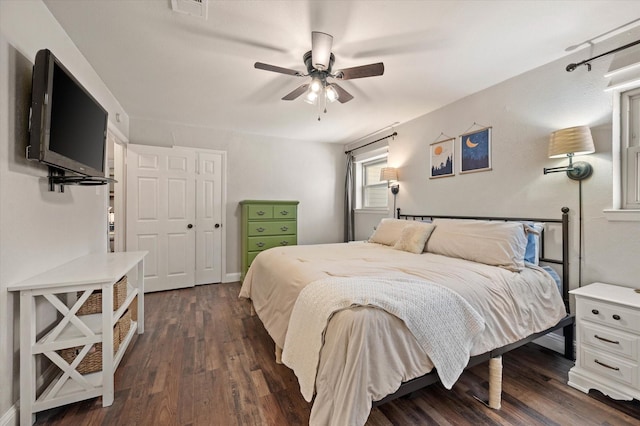 bedroom featuring ceiling fan, a closet, and dark hardwood / wood-style flooring