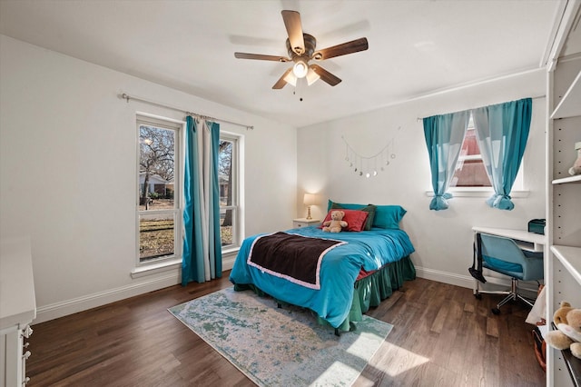 bedroom with ceiling fan, wood-type flooring, and multiple windows