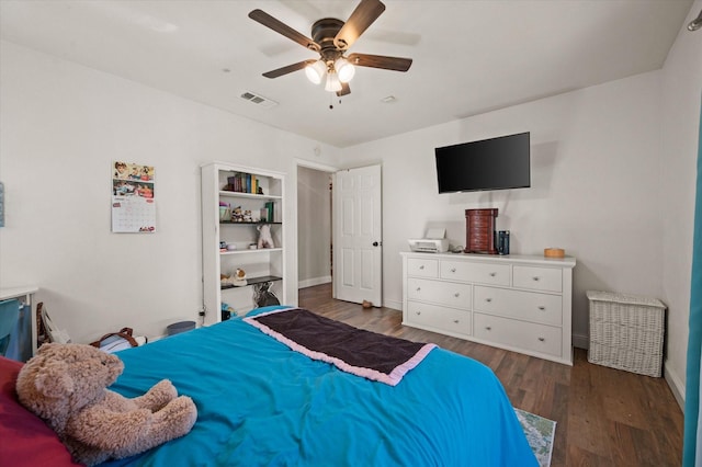 bedroom with ceiling fan and dark wood-type flooring