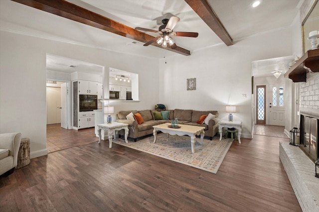 living room with ceiling fan, beam ceiling, a fireplace, and dark hardwood / wood-style floors