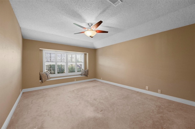 unfurnished room with a textured ceiling, carpet, ceiling fan, and vaulted ceiling