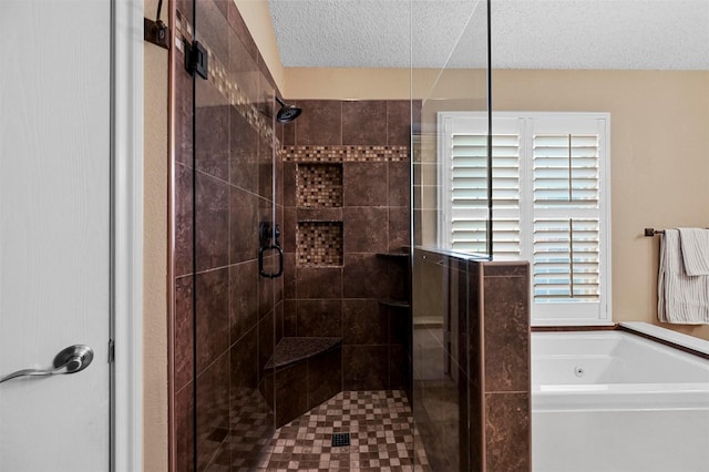 bathroom with independent shower and bath and a textured ceiling