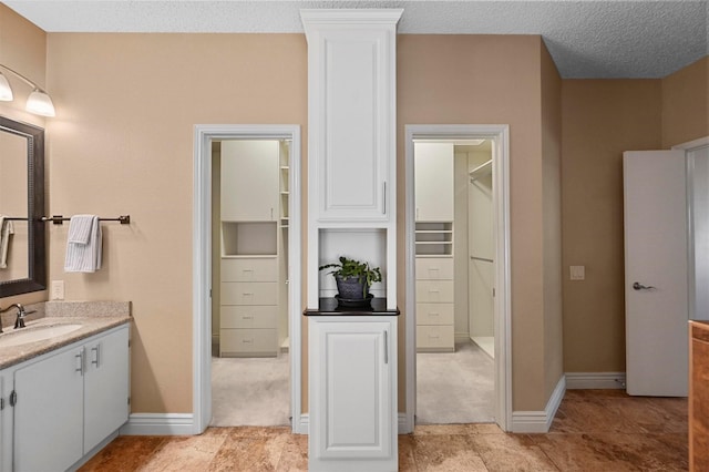 bathroom featuring vanity and a textured ceiling