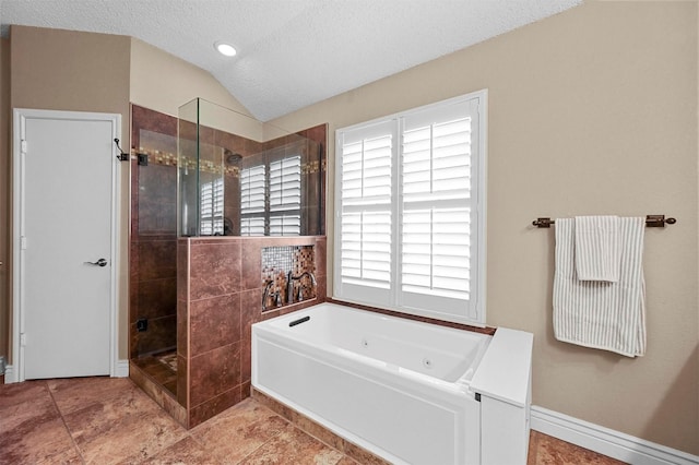 bathroom featuring a textured ceiling, vaulted ceiling, and independent shower and bath