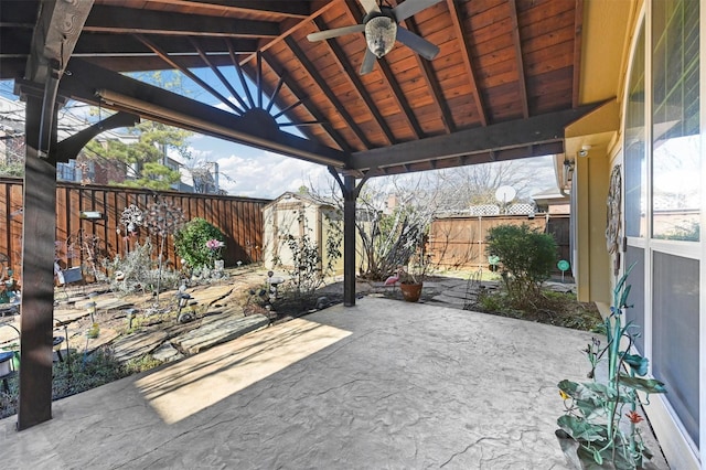 view of patio with a gazebo, ceiling fan, and a storage shed