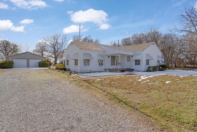 view of front of house with a garage and an outdoor structure