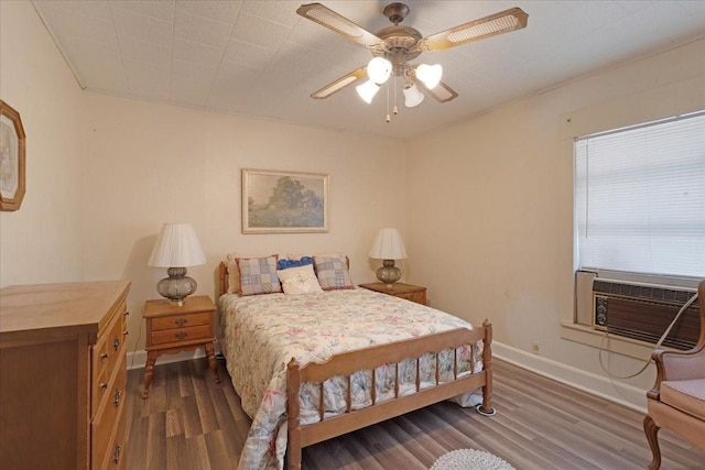 bedroom with ceiling fan, dark hardwood / wood-style flooring, and cooling unit