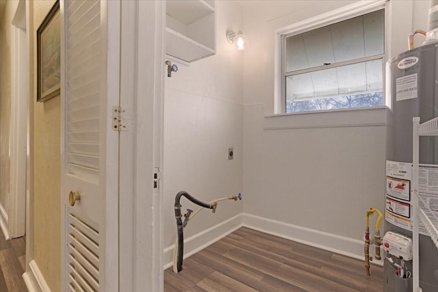 clothes washing area with water heater, dark hardwood / wood-style flooring, and electric dryer hookup