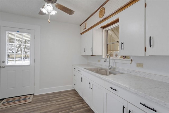 kitchen with sink, white cabinetry, and dark hardwood / wood-style floors