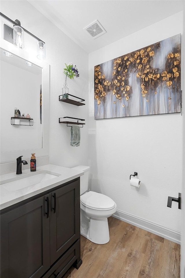 bathroom featuring hardwood / wood-style floors, vanity, and toilet