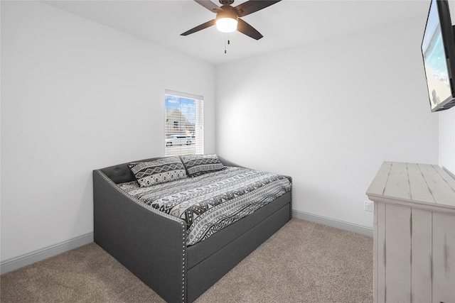 bedroom with ceiling fan and light carpet