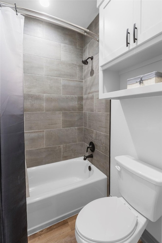 bathroom with toilet, shower / bath combo, and hardwood / wood-style floors