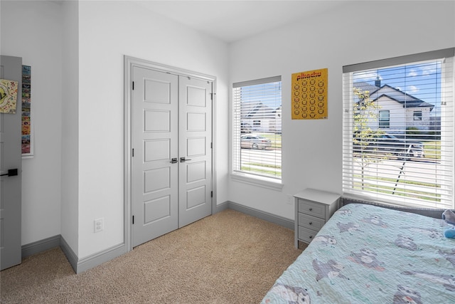 carpeted bedroom featuring a closet