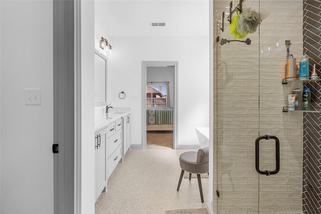 bathroom featuring an enclosed shower, vanity, and tile patterned flooring