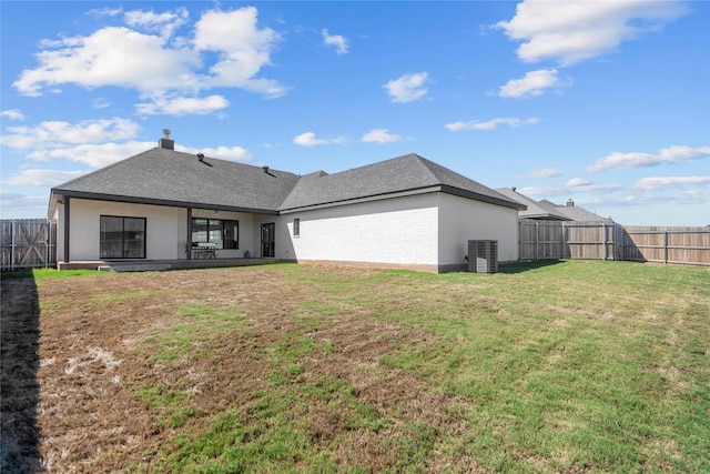 rear view of property featuring a patio, central air condition unit, and a yard