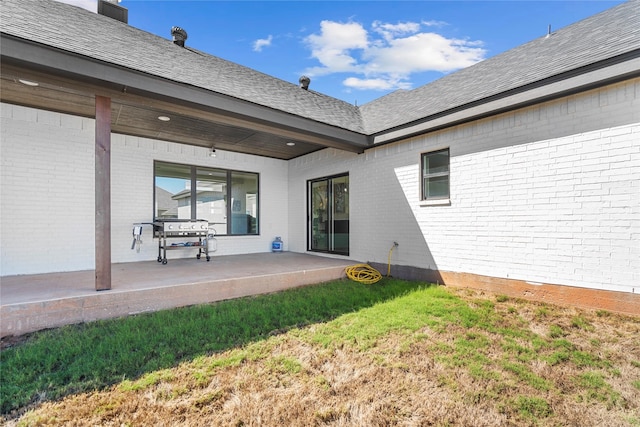 exterior space featuring a lawn and a patio area