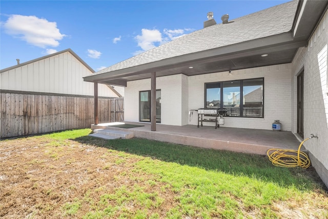 back of property featuring a yard and a patio