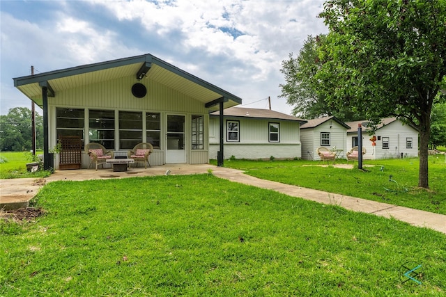 back of property featuring a lawn