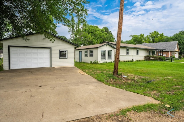 single story home featuring a garage and a front lawn