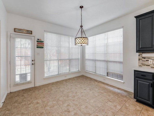 unfurnished dining area featuring light tile patterned floors