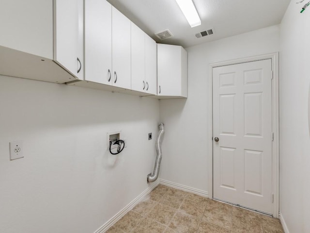 clothes washing area with washer hookup, cabinets, and hookup for an electric dryer