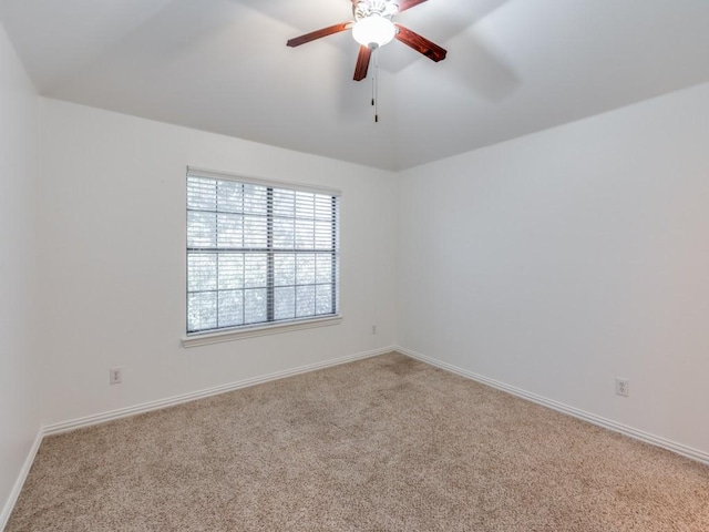 carpeted spare room featuring ceiling fan and lofted ceiling