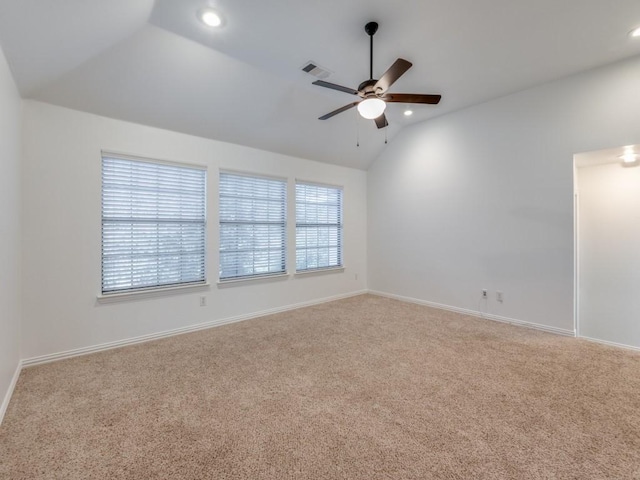 carpeted empty room featuring ceiling fan and vaulted ceiling