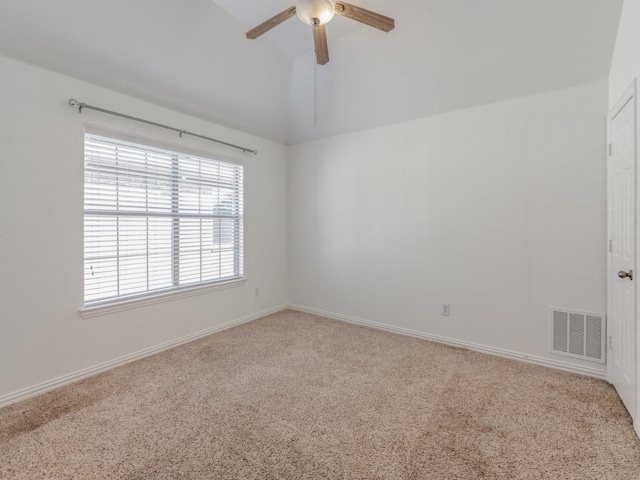 carpeted empty room with ceiling fan and vaulted ceiling