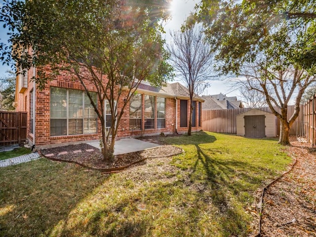 rear view of property featuring a lawn, a shed, and a patio area