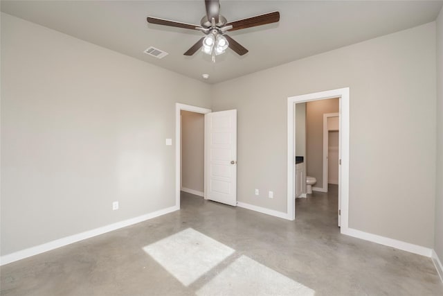 unfurnished bedroom featuring connected bathroom, ceiling fan, and a walk in closet