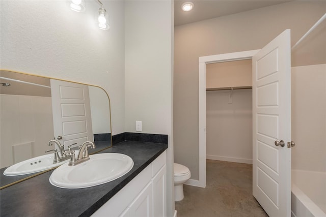 full bathroom featuring toilet, bathing tub / shower combination, and vanity