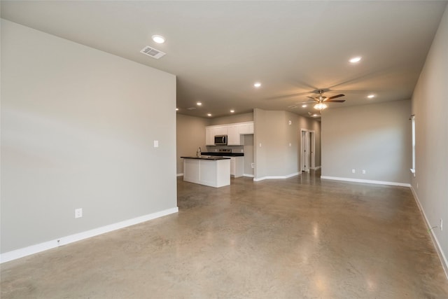 unfurnished living room with concrete floors and ceiling fan