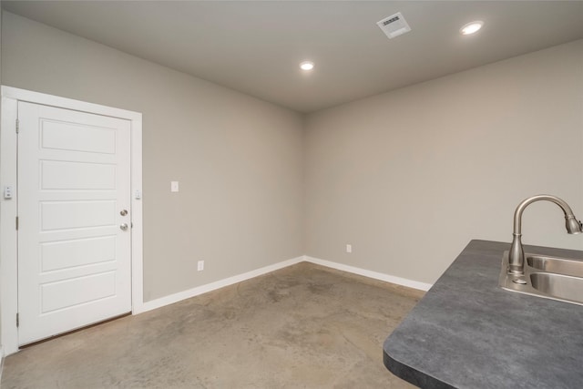 interior space featuring sink and concrete floors