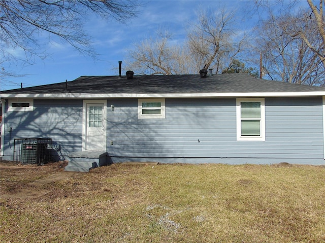 view of property exterior with a lawn and central AC unit