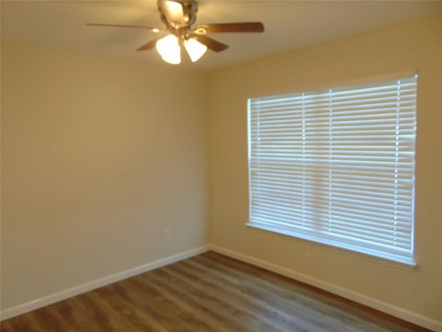 empty room featuring ceiling fan and hardwood / wood-style floors