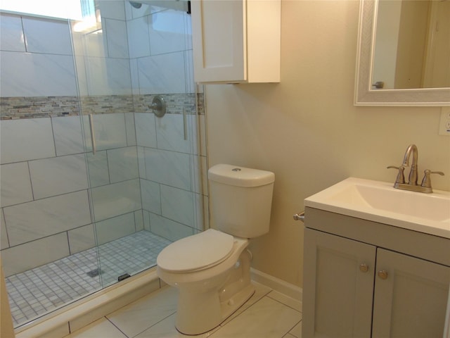 bathroom with vanity, toilet, tile patterned floors, and a shower with shower door